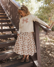 Load image into Gallery viewer, Ruffle Long Sleeve Tee in Bow, cream on a girl walking down stairs