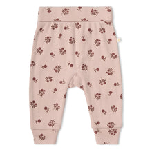 Load image into Gallery viewer, A pair of baby jogger pants in dusty pink with a small dark red floral print, laid flat on a white background.