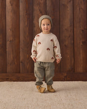 Load image into Gallery viewer, Front view of a child wearing a cream mushroom knit sweater with gray-green pants, tan boots, and a knit hat.