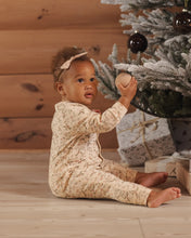 Load image into Gallery viewer, Organic Long John Pajamas in Holly Fleur on a baby by a holiday tree