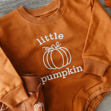 Load image into Gallery viewer, A rust-orange long-sleeve baby sweatshirt with 'little pumpkin' printed in white text and a pumpkin outline on the front, laid flat on a gray wood surface.