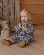 Load image into Gallery viewer, Relaxed Woven Jumpsuit in Winter Plaid on a seated baby, front view