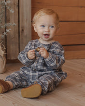 Load image into Gallery viewer, Relaxed Woven Jumpsuit in Winter Plaid on a smiling seated baby