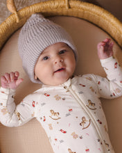 Load image into Gallery viewer, Close-up of a baby in a gray knit hat and cream Toy Chest footie, showing the neckline and front zipper.