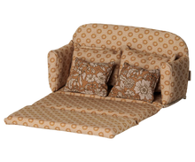 Load image into Gallery viewer, Maileg ocher mouse sofa bed unfolded into a bed, with an extended padded mattress and two floral pillows.