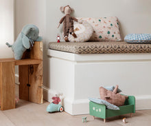 Load image into Gallery viewer, Soft mint plush elephant draped over a rattan doll bed beside a striped rabbit, with teddy bears and a miniature pram nearby.