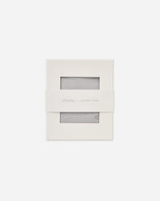 Load image into Gallery viewer, A minimalist cream-colored paper packaging box with two horizontal rectangular cutouts showing a light gray textured fabric inside, wrapped with a white paper band labeled 'sophia x QUINCY MAZE'.