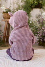 Load image into Gallery viewer, A child wearing a knitted hooded sweater with small pointed ears on the hood, photographed from behind in a softly styled indoor setting with plants and a wooden stool in the background.