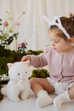 Load image into Gallery viewer, Child in a pink cardigan and white bunny ears gently patting Moon the Kitty plush on the head.