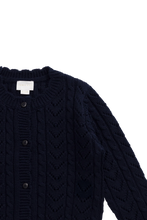 Load image into Gallery viewer, Close-up of a dark navy cable-knit cardigan sweater with a button front and ribbed collar, shown against a plain white background.
