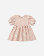 Load image into Gallery viewer, A baby girl's short-sleeve dress in dusty pink with a white ghost pattern, featuring puffed sleeves and a gathered skirt, shown against a plain light gray background.