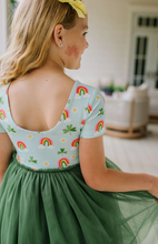 Load image into Gallery viewer, Woman wearing a dress with rainbow patterns in an indoor setting