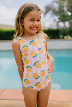 Load image into Gallery viewer, Young girl in a pink swimsuit with lemon pattern by a pool