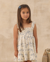 Load image into Gallery viewer, Young girl wearing a floral dress against a beige background