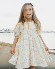 Load image into Gallery viewer, Young girl in a dress standing by a body of water.