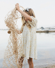 Load image into Gallery viewer, Child holding a fishing net by a body of water