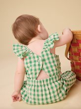Load image into Gallery viewer, Baby wearing a green checkered outfit sitting on a beige surface.