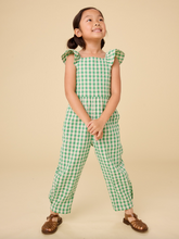 Load image into Gallery viewer, Young girl wearing a green checkered outfit on a beige background