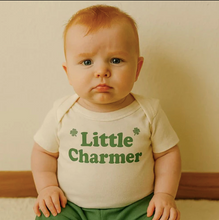 Load image into Gallery viewer, Baby wearing a onesie with 'Little Charmer' text against a plain background