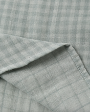Load image into Gallery viewer, Close-up of a folded green fabric with a subtle pattern