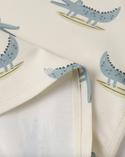 Load image into Gallery viewer, Beige fabric with blue crocodile illustrations on a white background