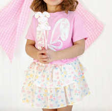Load image into Gallery viewer, Child wearing a pink top with a white and a floral skirt on a white background
