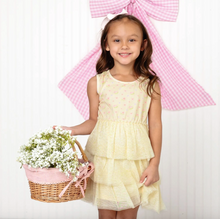 Load image into Gallery viewer, Young girl in a yellow dress holding a basket of flowers with a large pink bow in the background.