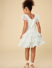 Load image into Gallery viewer, Young girl wearing a light green dress with ruffled sleeves and skirt on a beige background