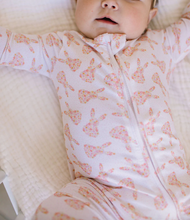 Load image into Gallery viewer, Baby wearing a white onesie with pink patterns on a white background