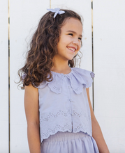 Load image into Gallery viewer, Young girl wearing a light purple outfit with ruffled collar against a white wooden background