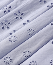 Load image into Gallery viewer, Close-up of light purple fabric with floral cut-out patterns