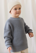 Load image into Gallery viewer, Child wearing a gray sweater and white knit hat against a light background