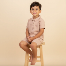 Load image into Gallery viewer, Child sitting on a stool wearing a matching pink outfit against a beige background