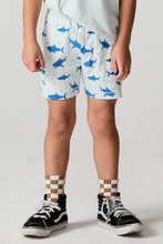 Load image into Gallery viewer, Child wearing shorts with shark pattern and checkered socks on a plain background