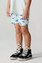 Load image into Gallery viewer, Child wearing shark-patterned shorts and checkered socks on a plain background
