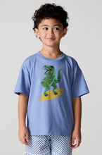 Load image into Gallery viewer, Child wearing a blue t-shirt with a green dinosaur graphic on a plain background