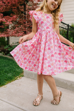 Load image into Gallery viewer, Young girl in a pink dress standing outdoors on a sidewalk.