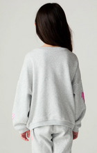 Load image into Gallery viewer, A child viewed from behind wearing a light gray heather sweatshirt and matching sweatpants, with small pink graphic accents on the sleeves, against a plain light gray studio background.