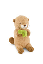 Load image into Gallery viewer, Front angled view of Ollie the Otter plush with brown paws, embroidered whiskers, and a green turtle held against its chest.