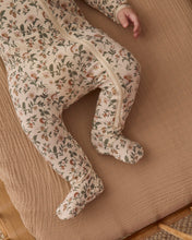 Load image into Gallery viewer, Close-up of the Holiday Floral footie’s enclosed feet and zipper extending down one leg.