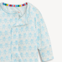 Load image into Gallery viewer, A close-up of a baby long-sleeve sleep sack or pajama top in white with a light blue angel pattern, featuring a colorful striped inner neck trim.