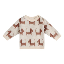 Load image into Gallery viewer, A baby knit sweater in cream with an all-over pattern of brown dachshund dogs, featuring ribbed cuffs, hem, and collar, and snap closures at the shoulder.