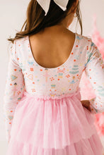 Load image into Gallery viewer, Close-up of the dress’s scooped back neckline, pastel holiday print, gathered waist, and pink tulle layers.