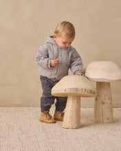 Load image into Gallery viewer, A toddler stands beside two large mushroom-shaped wooden toys in a softly lit indoor setting with a beige wall and textured rug.