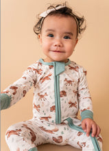 Load image into Gallery viewer, Baby wearing a onesie with animal prints on a beige background