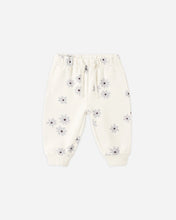Load image into Gallery viewer, Off-white jogger pants with a small gray and purple daisy print, featuring an elastic waistband and drawstring.
