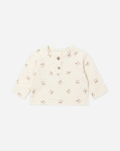Load image into Gallery viewer, Cream long-sleeve shirt with an allover rocking-horse print, round neckline, and two-button front placket.
