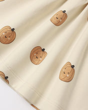Load image into Gallery viewer, Close-up of a cream-colored fabric with a repeating pattern of cute, smiling cartoon pumpkins in shades of brown and tan.
