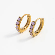 Load image into Gallery viewer, Pair of gold-tone hoop earrings with round pink opal stones, standing upright on a white background.

