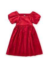 Load image into Gallery viewer, A red velvet toddler dress with short puff sleeves, a square neckline, and a gathered skirt, shown flat on a white background.
